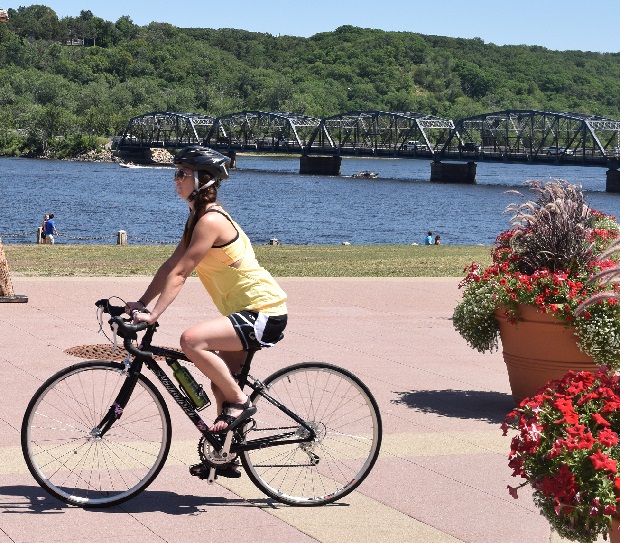 Here a cyclist enjoys riding her bike along the Scenic St Croix River to the Browns Creek Trail, in Stillwater, MN.