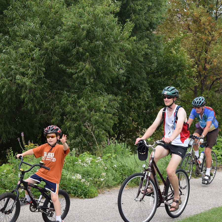 A family having fun riding bike on city trails in Brooklyn Park, MN.