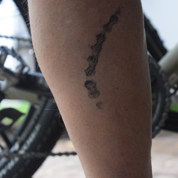 A chainring tattoo is common on the right leg when the bike chain is dirty.