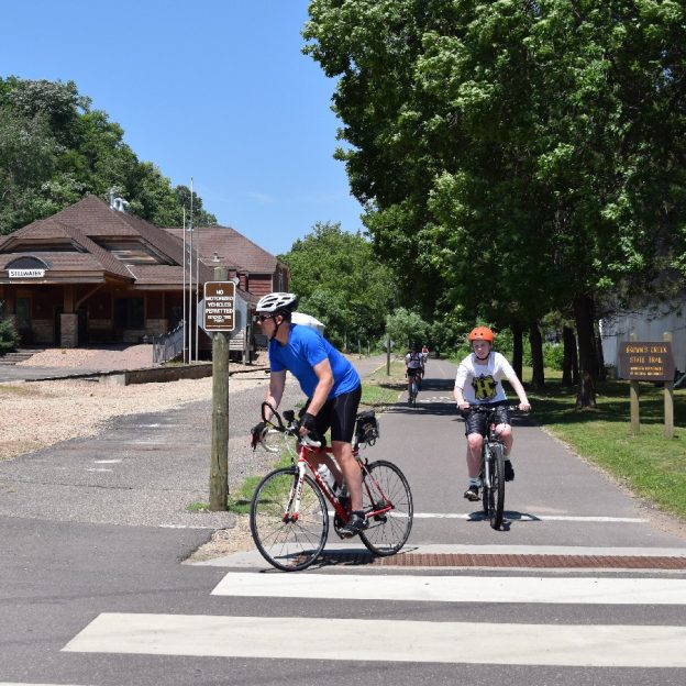 Another beautiful day on the Browns Creek Trail. Here in this photo a couple of cyclist enjoy the trail riding into Stillwater, MN.