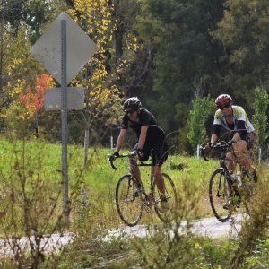 Here these cyclists are enjoying Minnesota's peak riding time on the Red Jacket Trail, near Mankato.