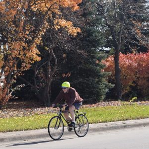Still finding the fall color in the Twin Cities. Here in this photo a cyclist is on a bike route headed for the Old Cedar Bridge recently restored in Bloomington, MN.