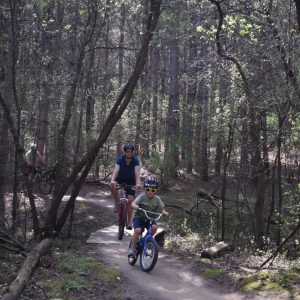 This little tyke is out enjoying his trek with his dad.