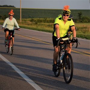 These RAGBRAI cyclist are wearing safe visible clothing with an extra dab of orange.