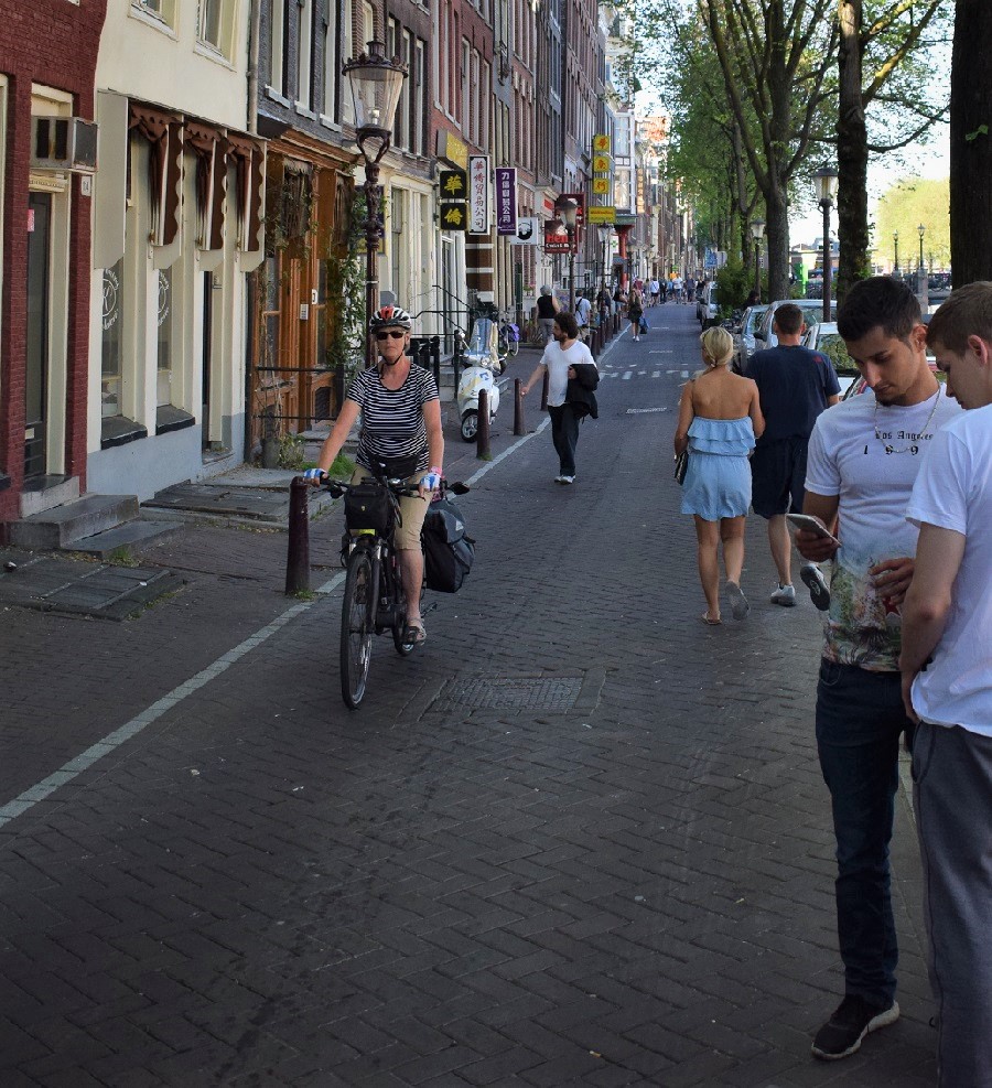 Pedaling along the bike lane in Amsterdam