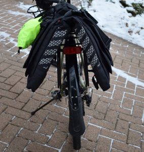 The panniers exterior offer reflective material and straps to attach blinking lights for more visibility.