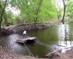 Enjoy an upper body stretch pulling you and your bike across river.