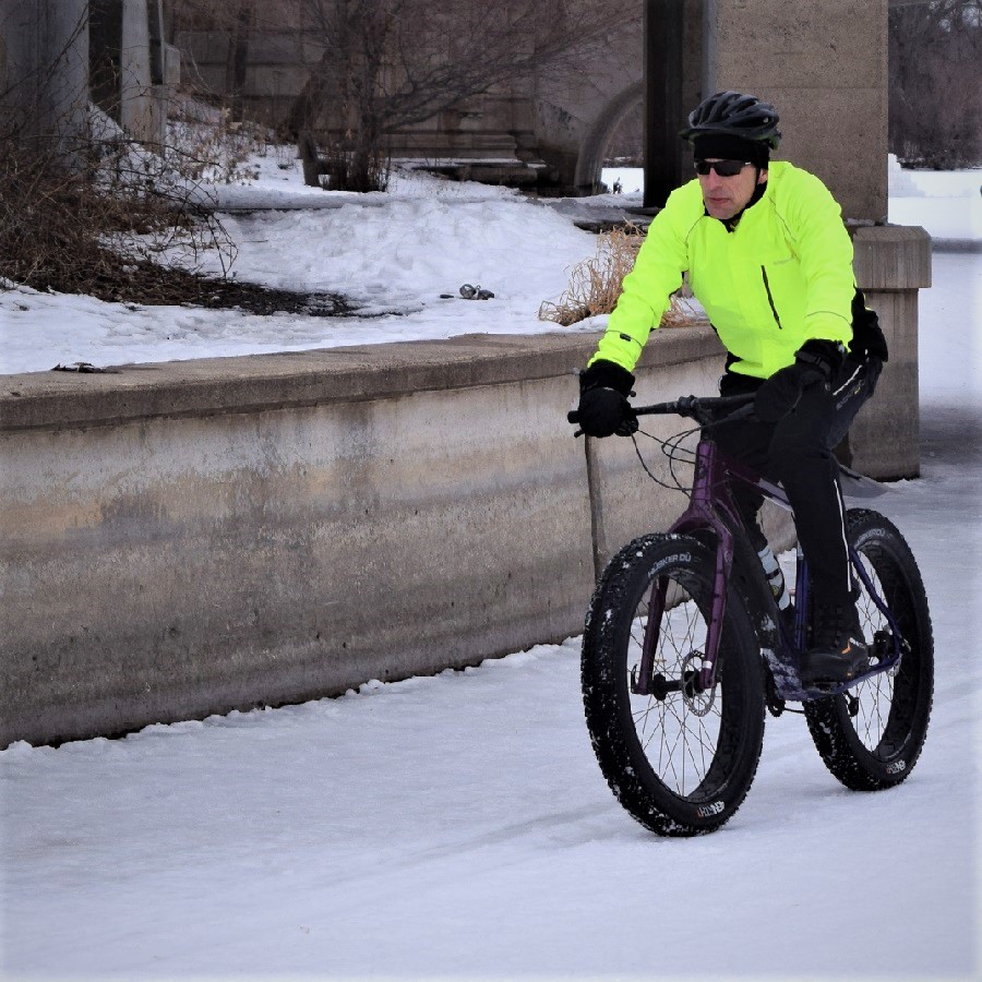 Here in today's bike pic this bold north biker dude commutes to work on his fatty, through the channel from Lake of the Isles to Lake Calhoun, into the Monday morning sun, in Minneapolis.