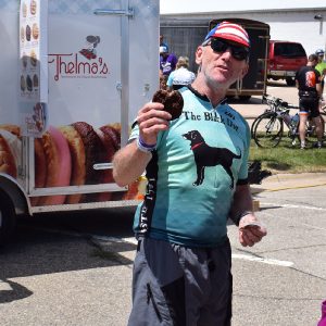 Sharing an ice cream sandwich with friends, after a hard days ride, on the Register's Annual Great Bicycle Ride Across Iowa (RAGBRAI), an annual tradition.