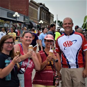 Sharing an ice cream treats in front of the AAA The Auto Club Group's booth, on RAGBRAI