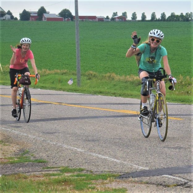 It’s Friday and time to ride off for another weekend of fun that maybe includes planning some bike trips this coming summer. Here in this photo, last summer, we captured a couple biker chicks on RAGBRAI 2017 having fun. 