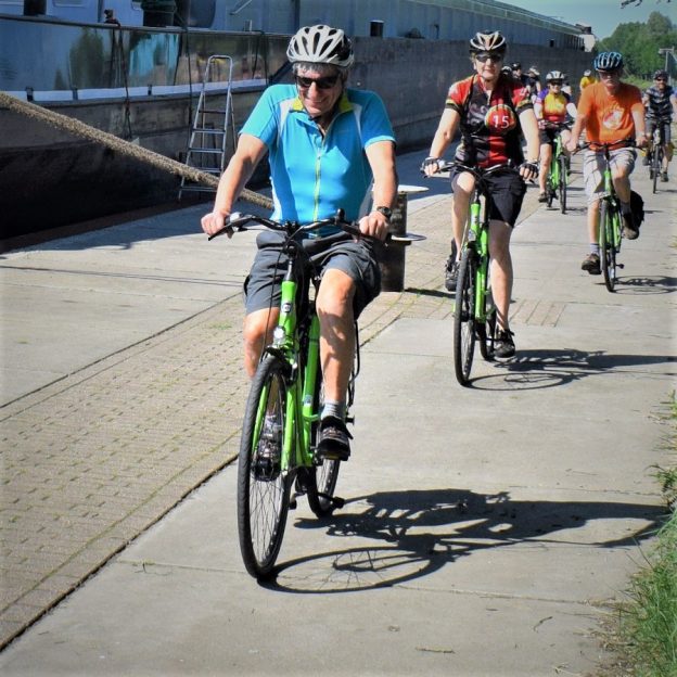 Fond summer memories riding the canals and river in the Netherlands as these cyclist demonstrates enjoying a bike and barge tour from Amsterdam to Bruge.