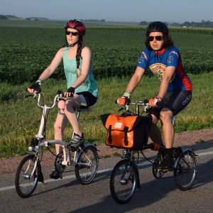 Riding into the morning sun as our spring weather, feels more like June temperatures. Today's photo was taken on RAGBRAi and shows a biker chick and dude having a great time along the route. What a fun way to see Iowa!