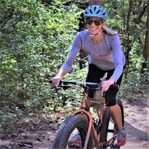 Riding into the Monday morning sun as our spring weather, feels more like June temperatures. Today's photo was taken on a Lebanon Hills Trail, in Eagan, MN with this biker chick having a great time. What a fun way to start the week!