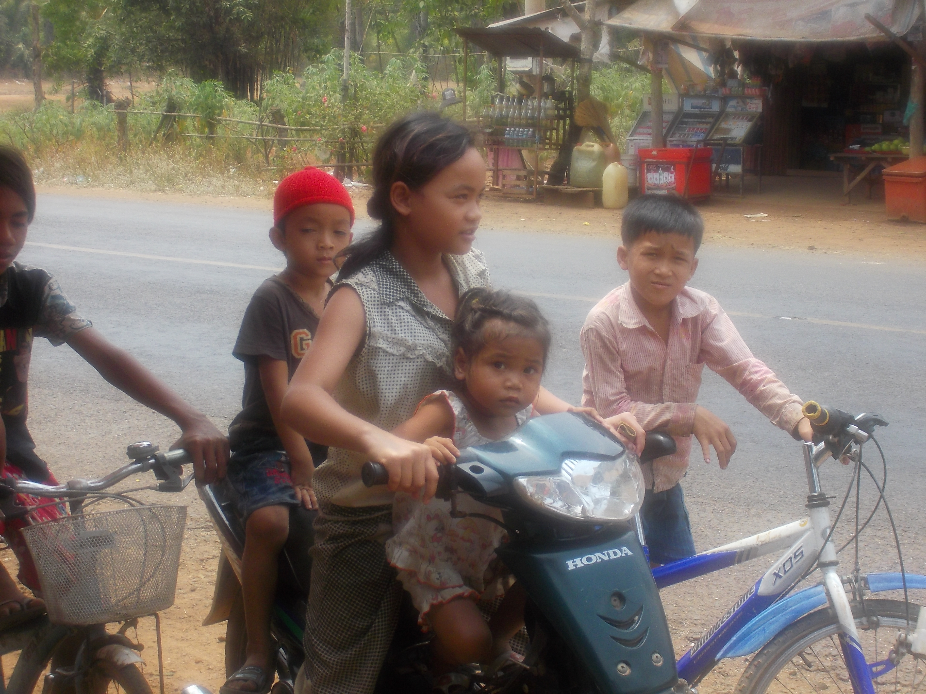 Cambodian Family maneuvering the highway