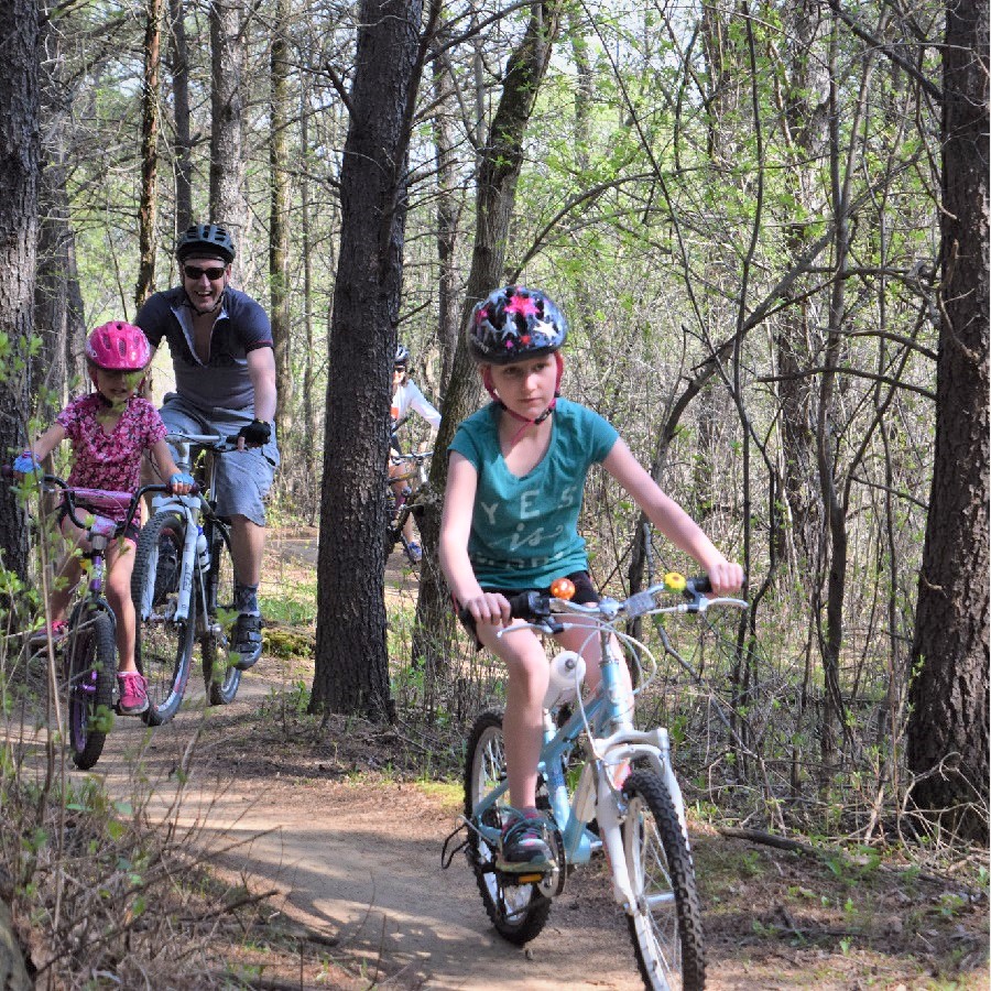 A family enjoying a true north bike experience in the forest.