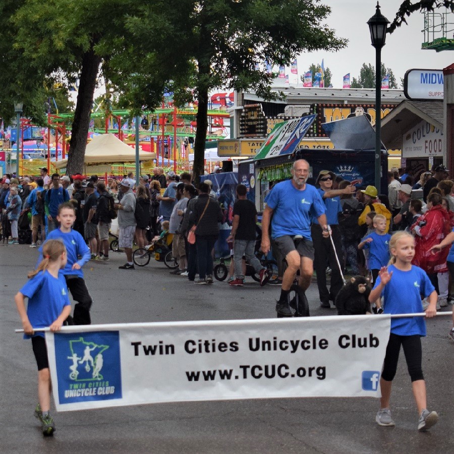 AT THE MINNESOTA STATE FAIR PARADE, ITS FUN TO SEE THE UNI-CYCLISTS RIDING AMONG THE FLOATS AND MARCHING BANDS.