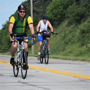 Here in this bike pic, we captured this biker dude, with a green jersey on, having fun pedaling into the Thursday morning sun, riding across Iowa.