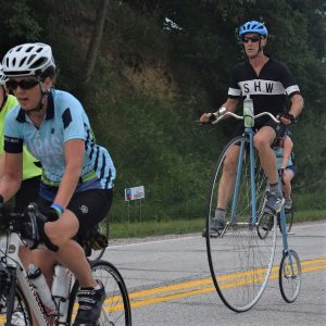 Here in this Bike Pic, we captured this biker dude on an original bike wheel bike, having fun pedaling across Iowa. See more fun photo on the RAGBRAI 2018 website.