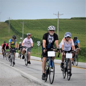 Here in this bike pic, digging through our summer archives, we captured this biker couple wearing altered wedding attire as they pedaled across Iowa. See more fun photos on the RAGBRAI 2018 website.