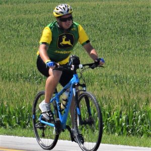 This Bike Pic Friday digging through the summer archives we found this biker dude riding like a Deere past the cornfields in Iowa on Ragbrai.