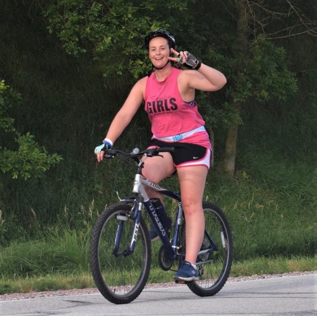 This Saturday bike pic, looking at the summer archive as warmer weather slowly melts the snow, we found a picture of this biker chick riding across Iowa,
