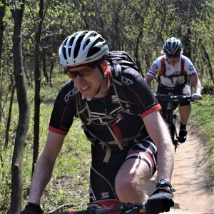 This Bike Pic Monday, we captured these two mountain bikers, out on the trail having fun as the morning sun enhances the view of the trail ahead of them.