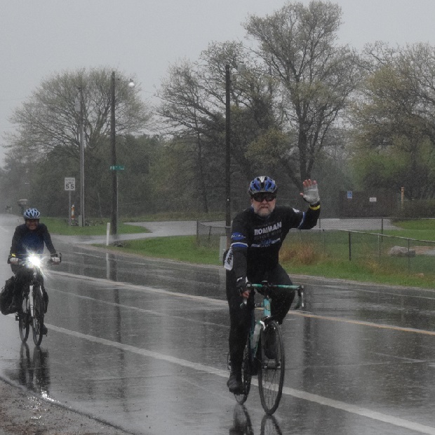 Two of 3,000 bike riders riding in the rain at the 50th MN Ironman Sunday, yesterday.