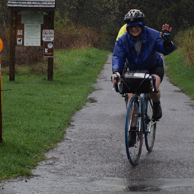Another MN Ironman bike rider riding in the rain at the 50th anniversary event. 