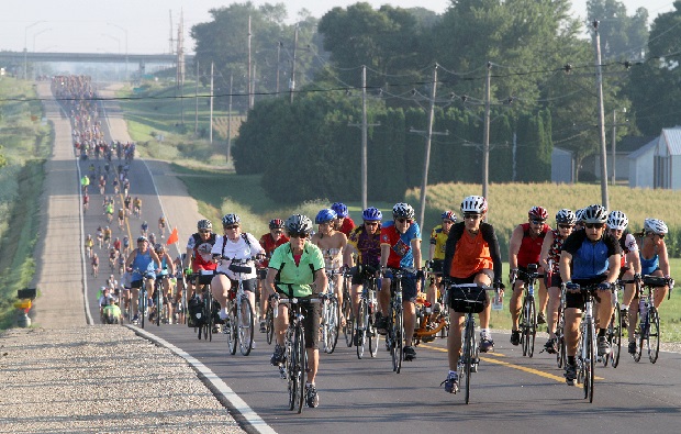 Riders make their way along the RAGBRAI route with helmets on.